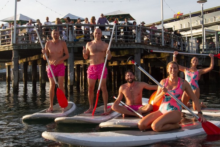 a little girl riding on the back of a boat