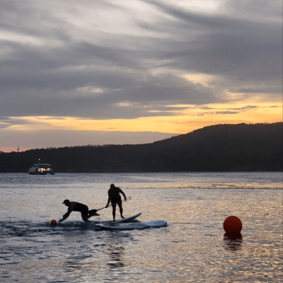 a man standing next to a body of water