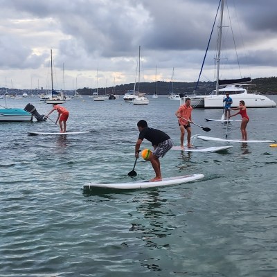 a group of people riding on the back of a boat in the water