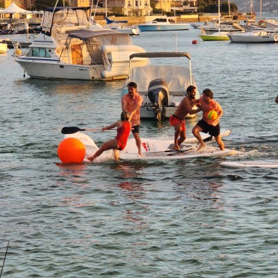 a group of people in a small boat in a body of water