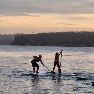 a man standing next to a body of water
