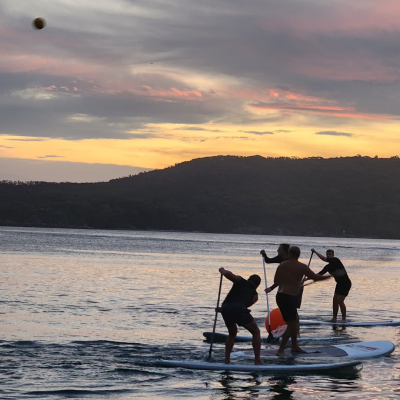 a man standing next to a body of water